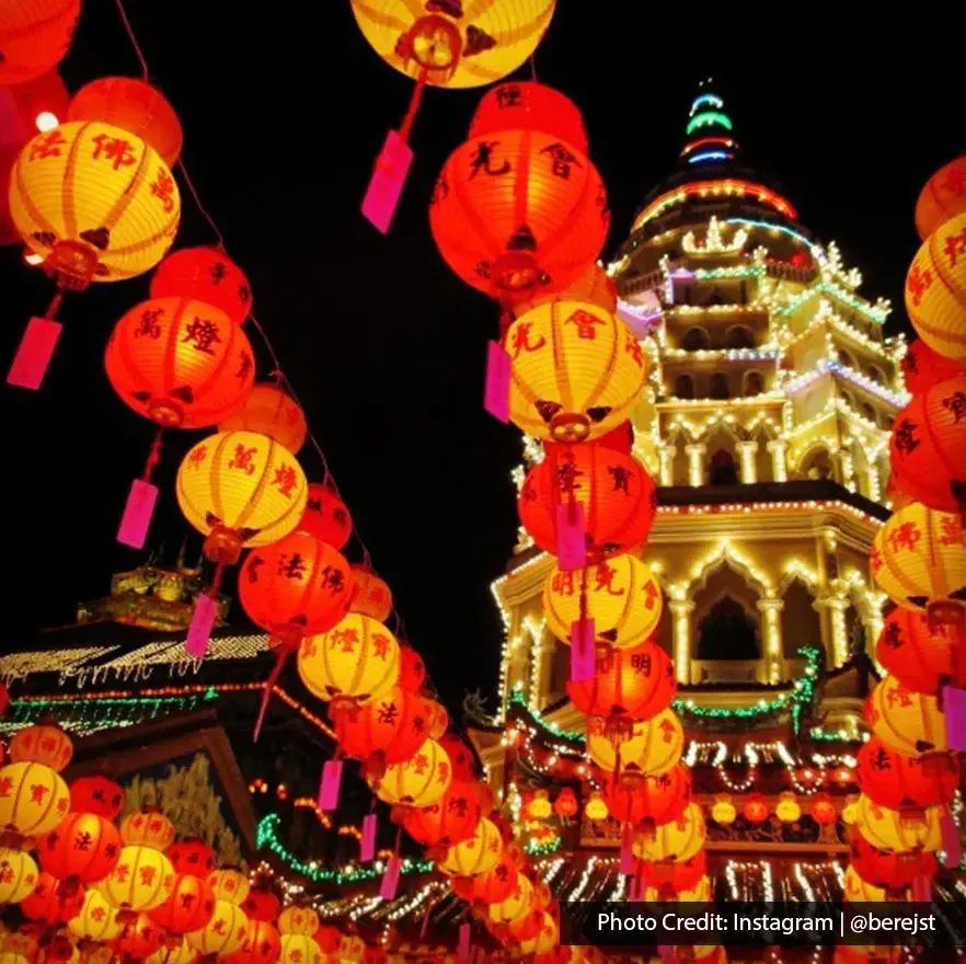 Colorful lantern display brightly lit Kek Lok Si temple at night.
