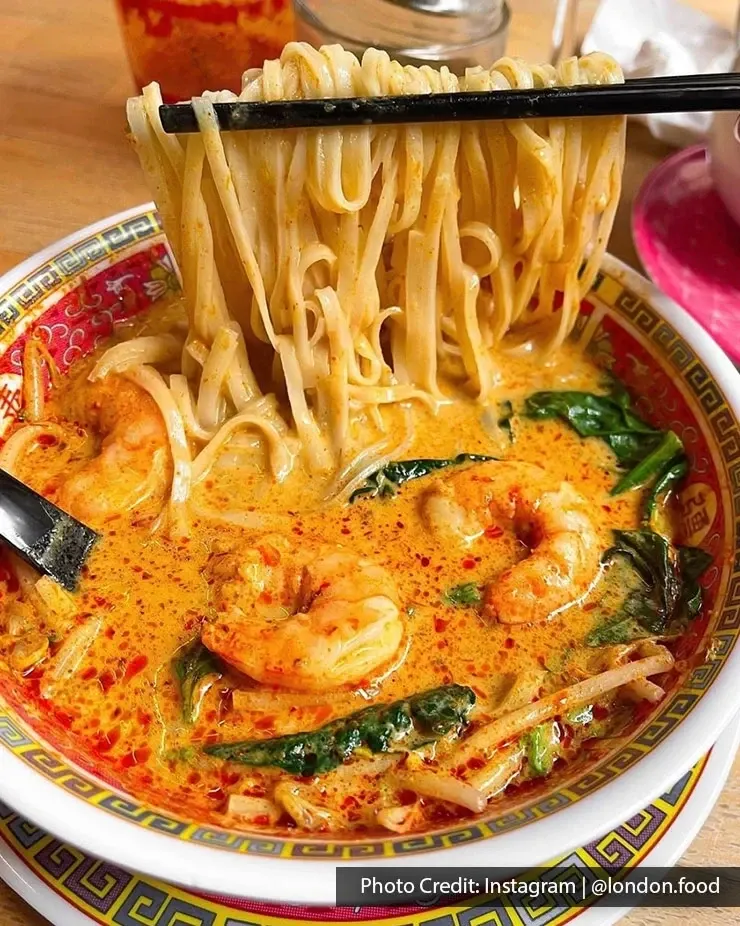 Prawn laksa with noodles, sprouts and leafy greens.