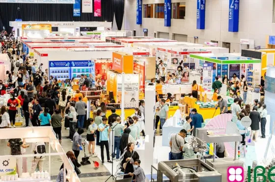 A large crowd of people interacting and viewing displays at IBE International Beauty Expo - Imperial Lexis Kuala Lumpur