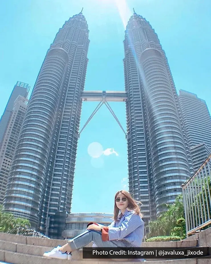 Visitor posing on steps in front of the Petronas Twin Towers