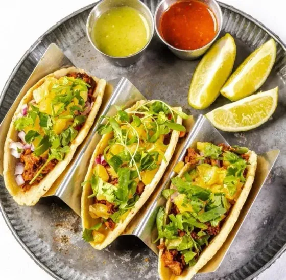 tacos with lime wedges from Uptown 66 Taqueria in MiMo District, Miami