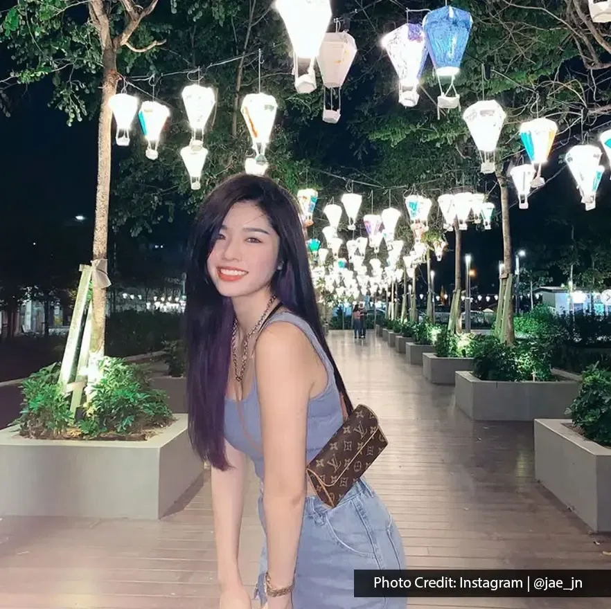 Smiling woman enjoying a night walk at Sia Boey Urban Archaeological Park.