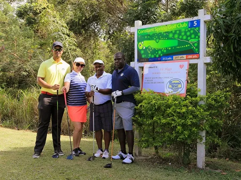 Four golfers on the green showcasing exciting things to do in Kingston Jamaica near Jamaica Pegasus Hotel