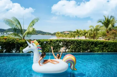 Mother and daughter enjoying the pool on the unicorn float - Lexis Hibiscus Port Dickson