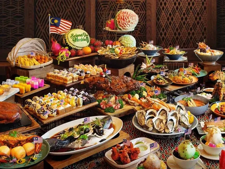 A buffet table showcasing a colorful array of traditional Malaysian dishes - Imperial Lexis Kuala Lumpur