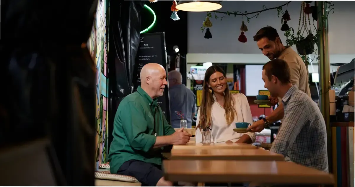 A group sits down for coffee at the Adelaide Central Market.