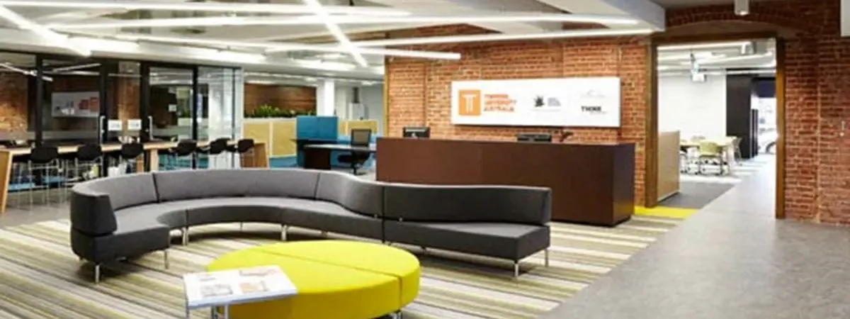 Collaborative study space with seating and a brick wall at Torrens University, near Ibis Adelaid