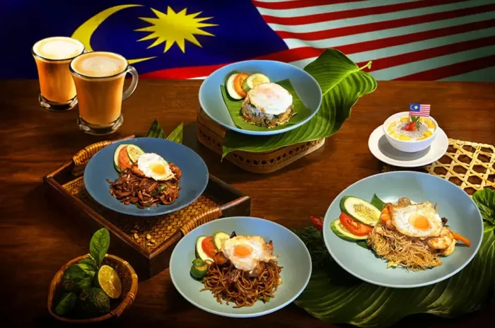 A table filled with various Malaysian dishes and drinks at Aqua Coffee House - Lexis Port Dickson