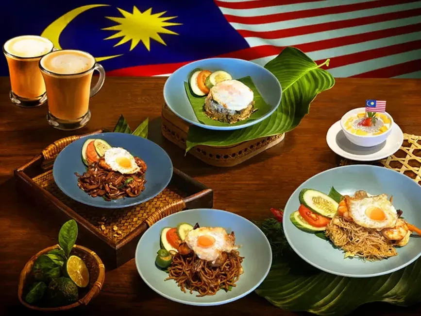 A table filled with various Malaysian dishes and drinks at Roselle Coffee House - Grand Lexis Port Dickson