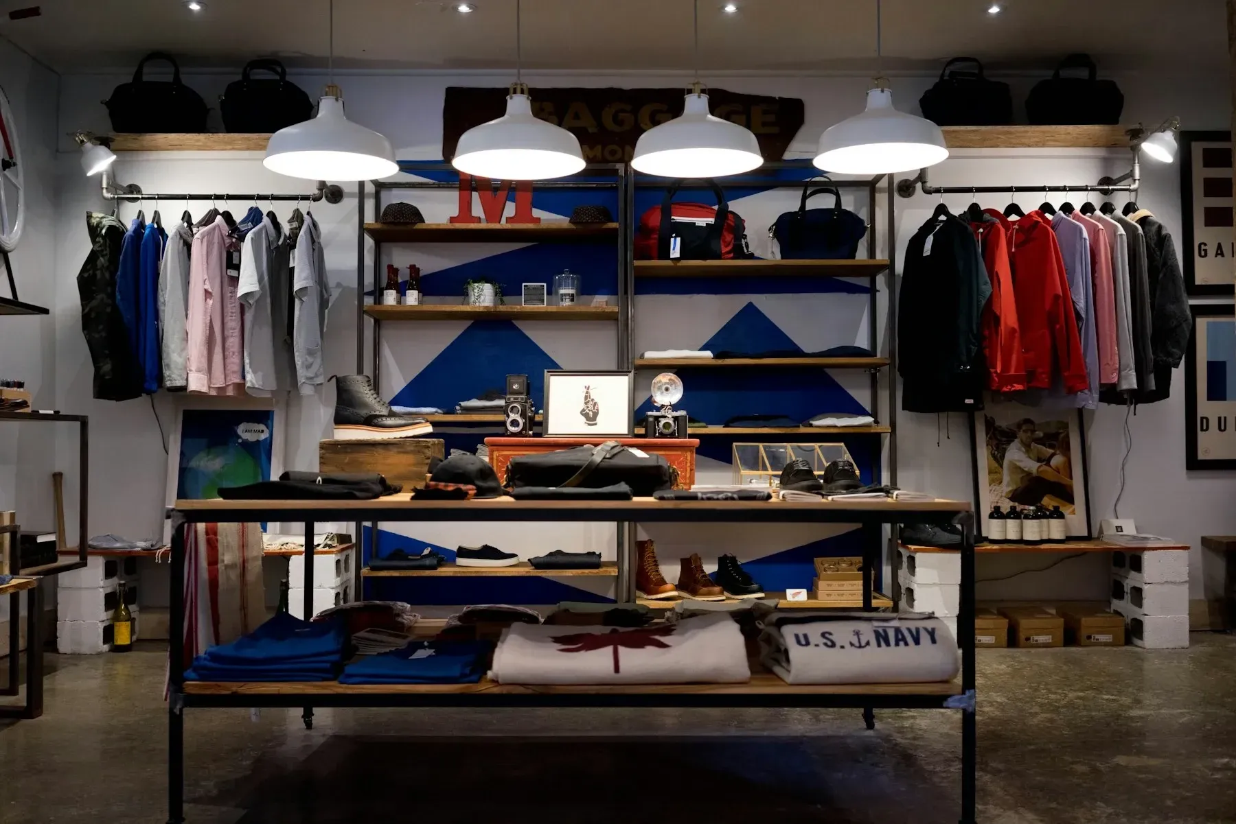 A boutique interior with clothing racks and warm shelf lighting