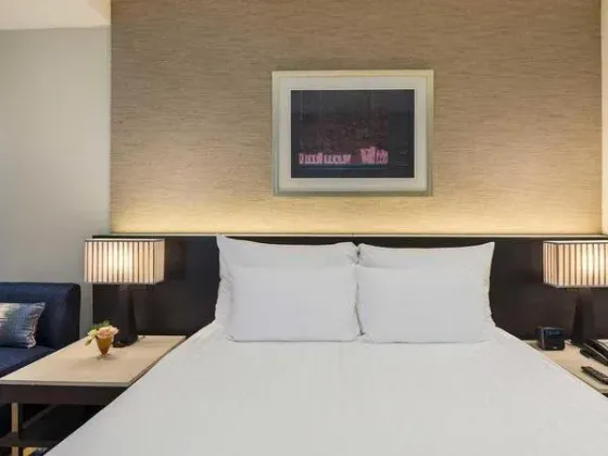 King size bed in a hotel room at Emporium Suites by Chatrium