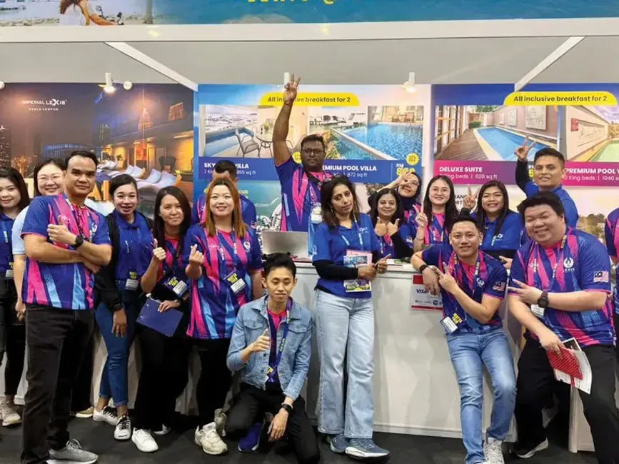 Lexis Hotel Group staff posing for a photo at Matta Fair - Lexis Hotel Group