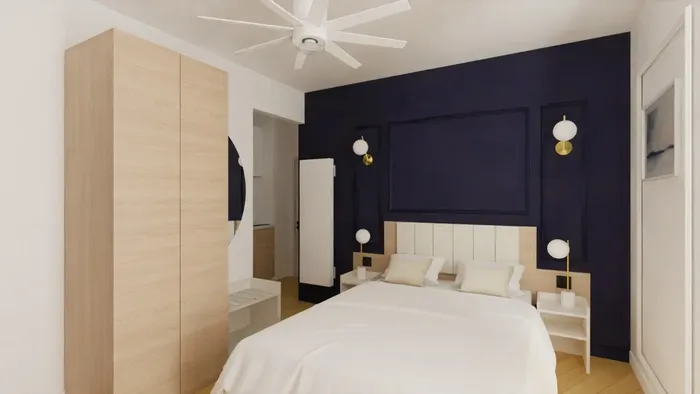 Chambre à coucher élégante avec lit double et mur bleu nuit, chez Les Sources Callou