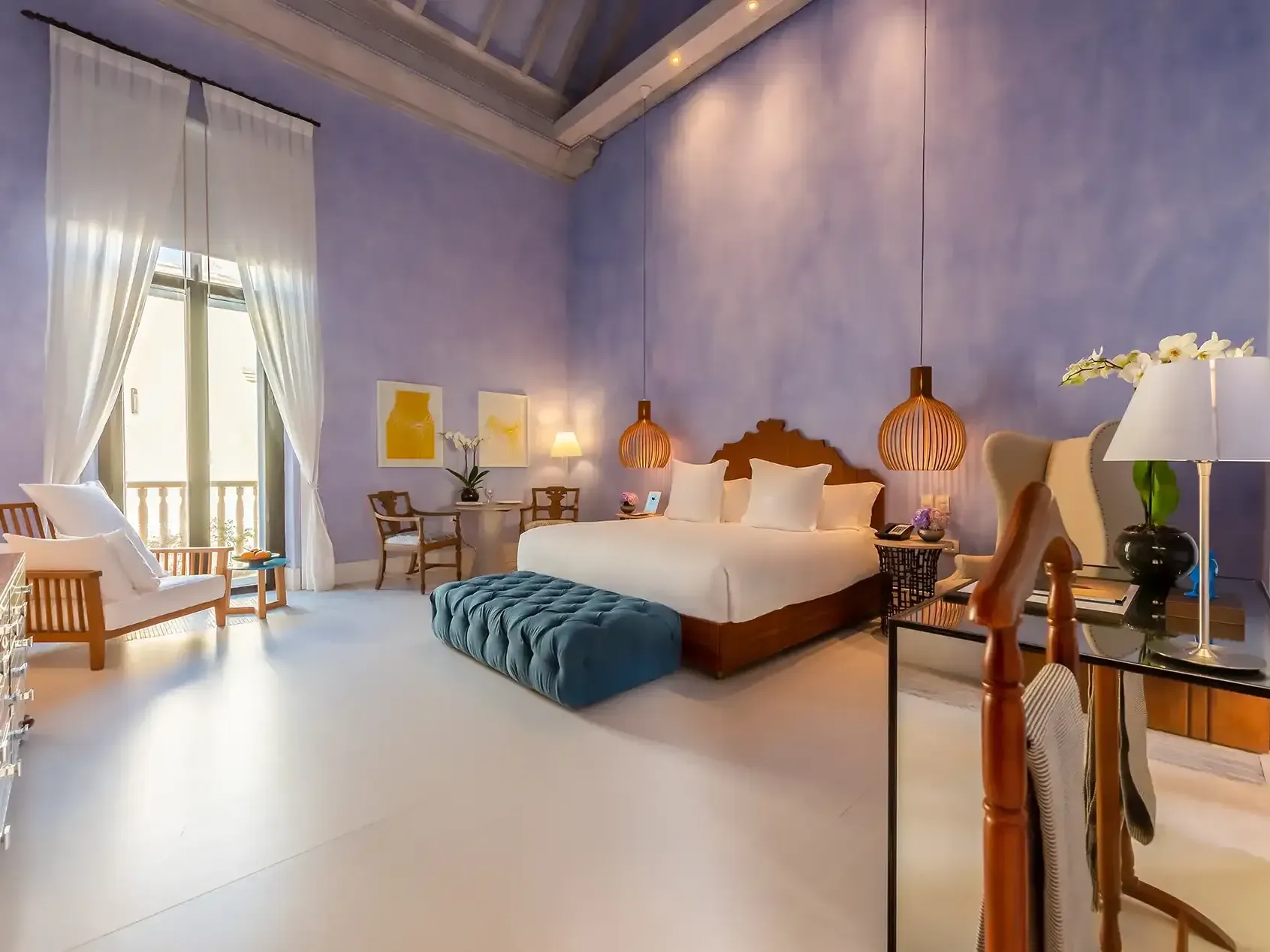 Luxurious Colonial Suite bedroom with street view at the Charleston Santa Teresa Hotel in Cartagena, Colombia.