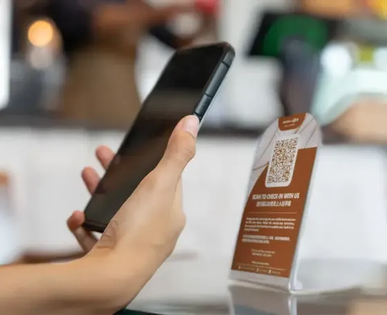 An individual using their phone to scan a QR code - Imperial Lexis Kuala Lumpur