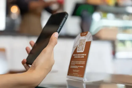 An individual using their phone to scan a QR code - Lexis Hotels & Resorts