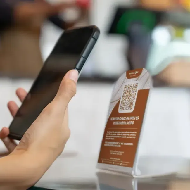 An individual using their phone to scan a QR code - Imperial Lexis Kuala Lumpur