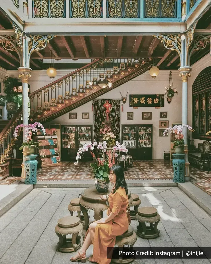 Pinang Peranakan Mansion interior with vintage staircase and orchids – Lexis Suites Penang