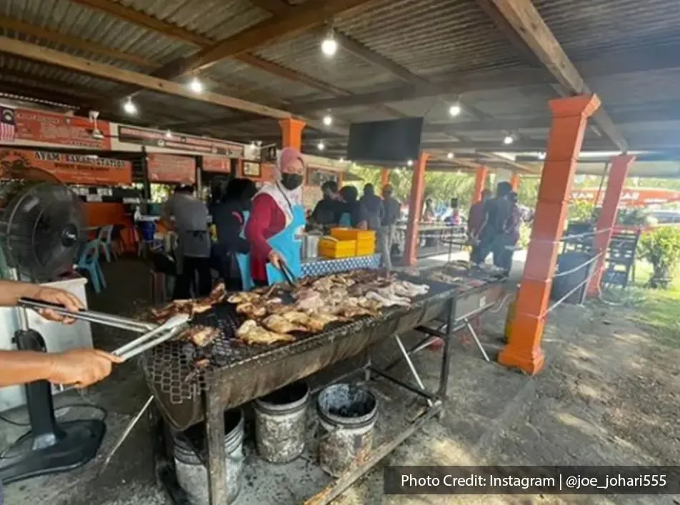 A lady is grilling the chicken equally