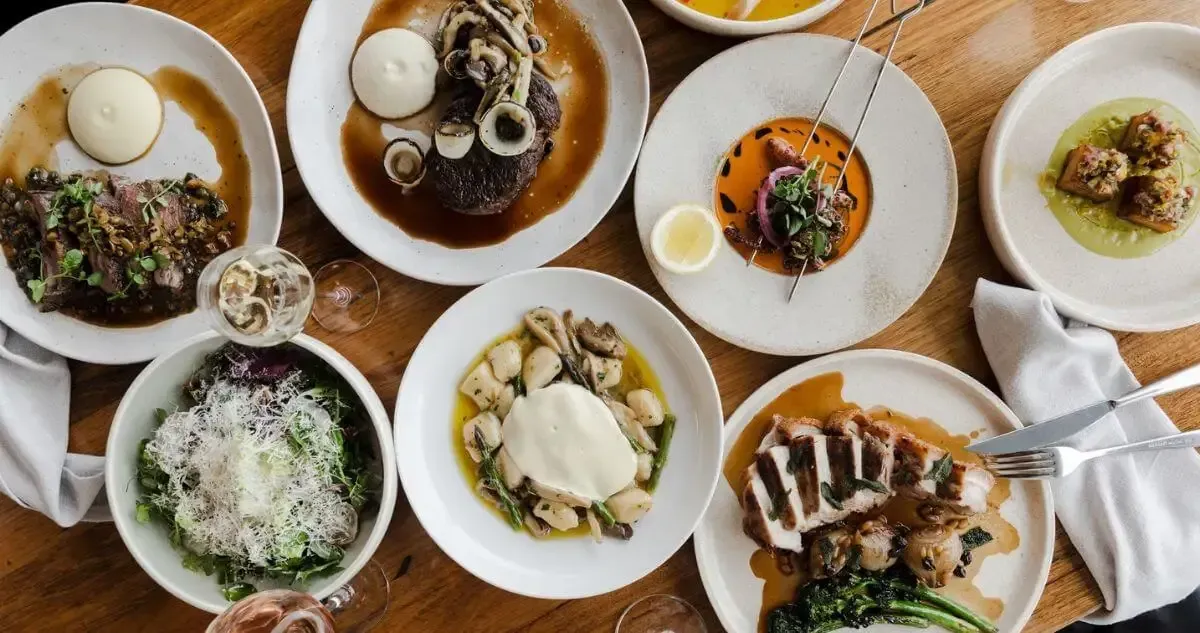 Top down view of 8 dishes on a table at Grain on the Silos