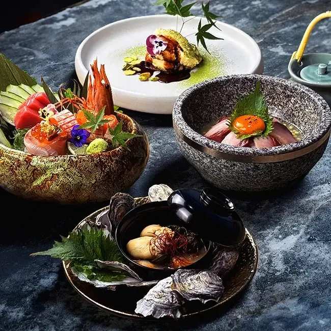 An array of Japanese dishes neatly arranged on a table at Umi Japanese Restaurant, Imperial Lexis KL - Lexis Hotels & Resorts
