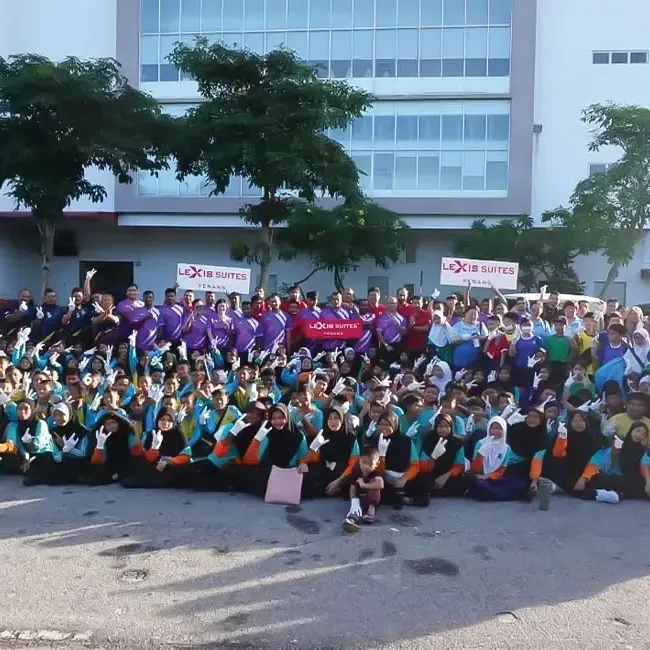 A group of people posing for the photo in front of a hotel - Lexis Suites Penang
