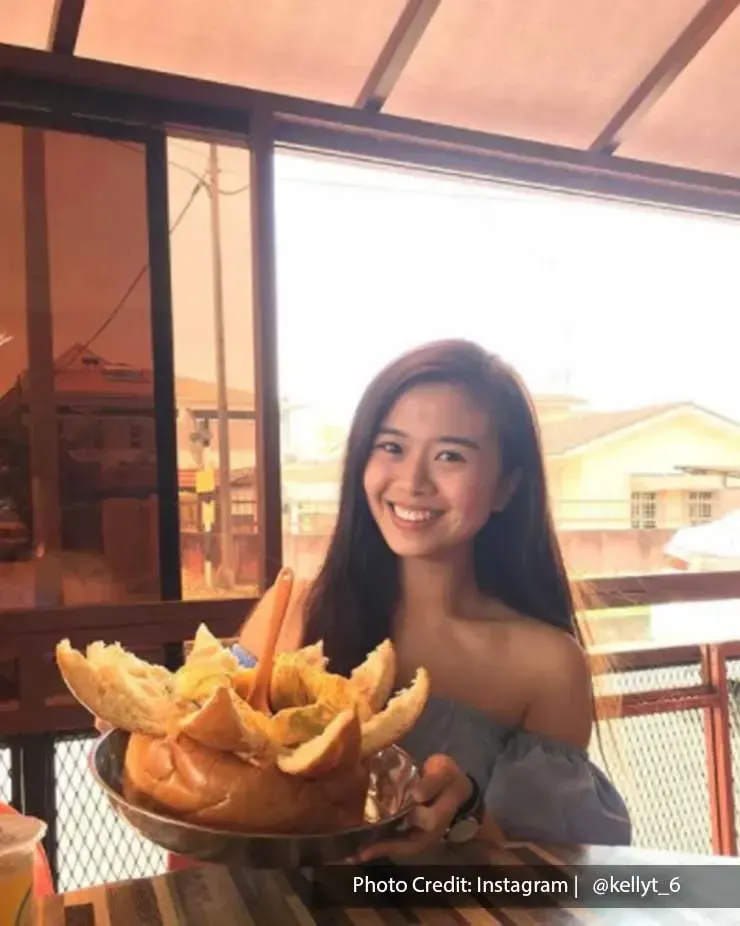 Woman holding a plate of curry bun from Lucky King Bun - Lexis Hibiscus