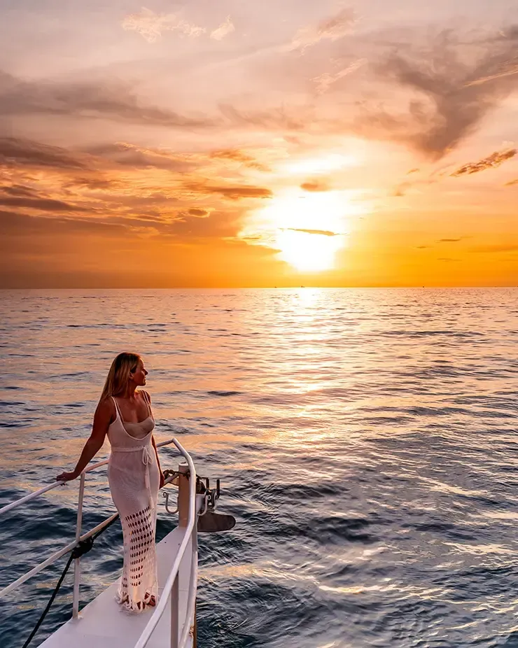 Sunset cruise view with woman on a yacht- Lexis Hibiscus Port Dickson