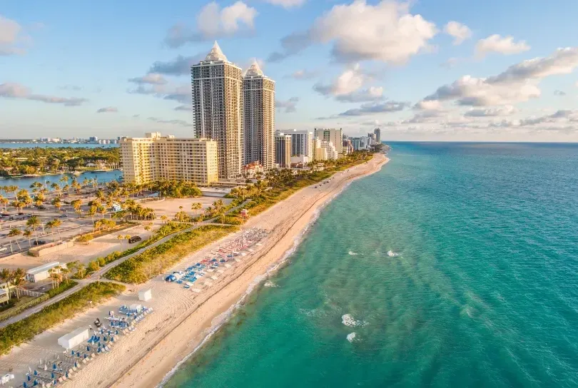 A beachside cityscape with tall buildings and a beach