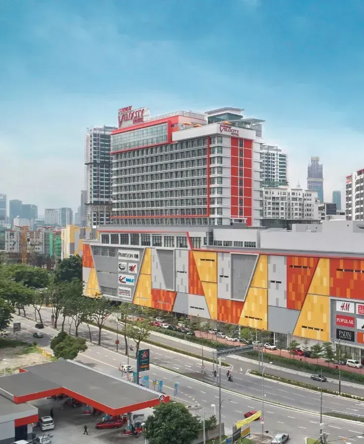 Sunway Velocity Hotel and Mall, with a colorful facade and the city skyline in the background