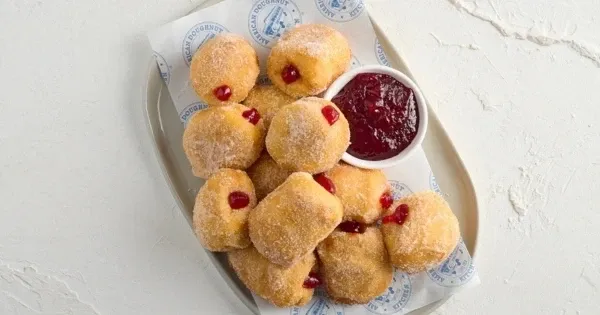 A plate of miniature jam-filled doughnuts
