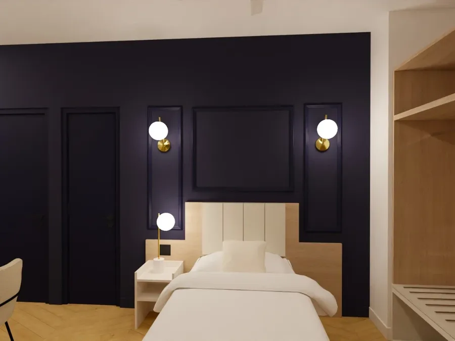 Chambre simple élégante avec lit et lampes murales décoratives à Les Sources Callou, Vichy.