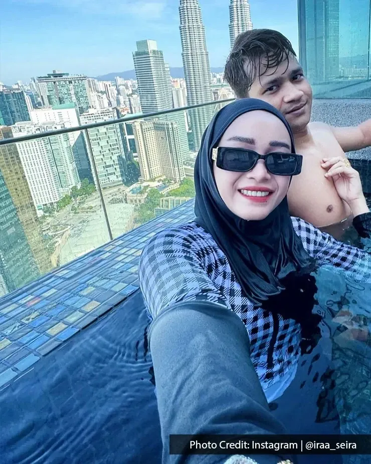 A couple enjoying their private pool, with a picturesque KLCC skyline serving as the backdrop.