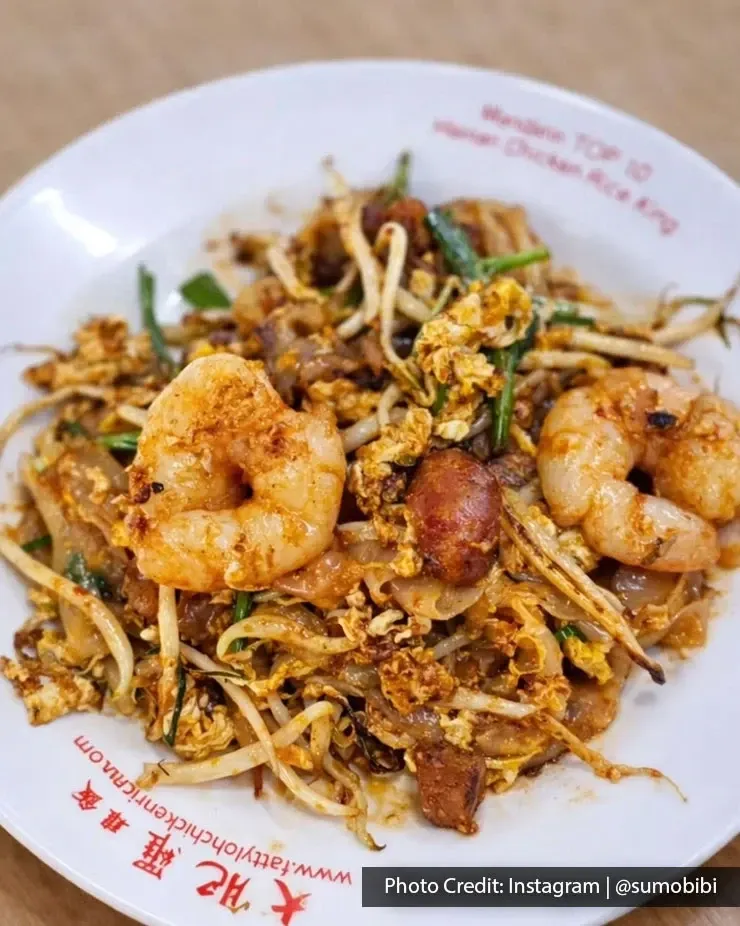 Prawn char kway teow served on white plate.