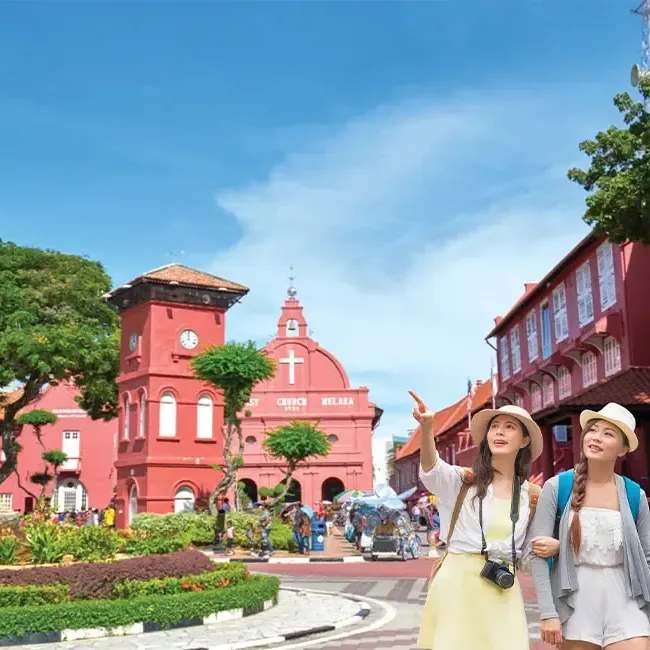 Two women strolling together along a busy street - Lexis Hotels & Resorts