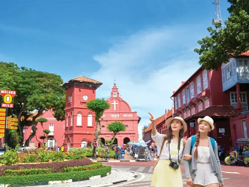 Two women strolling together along a busy street - Lexis Hotels & Resorts