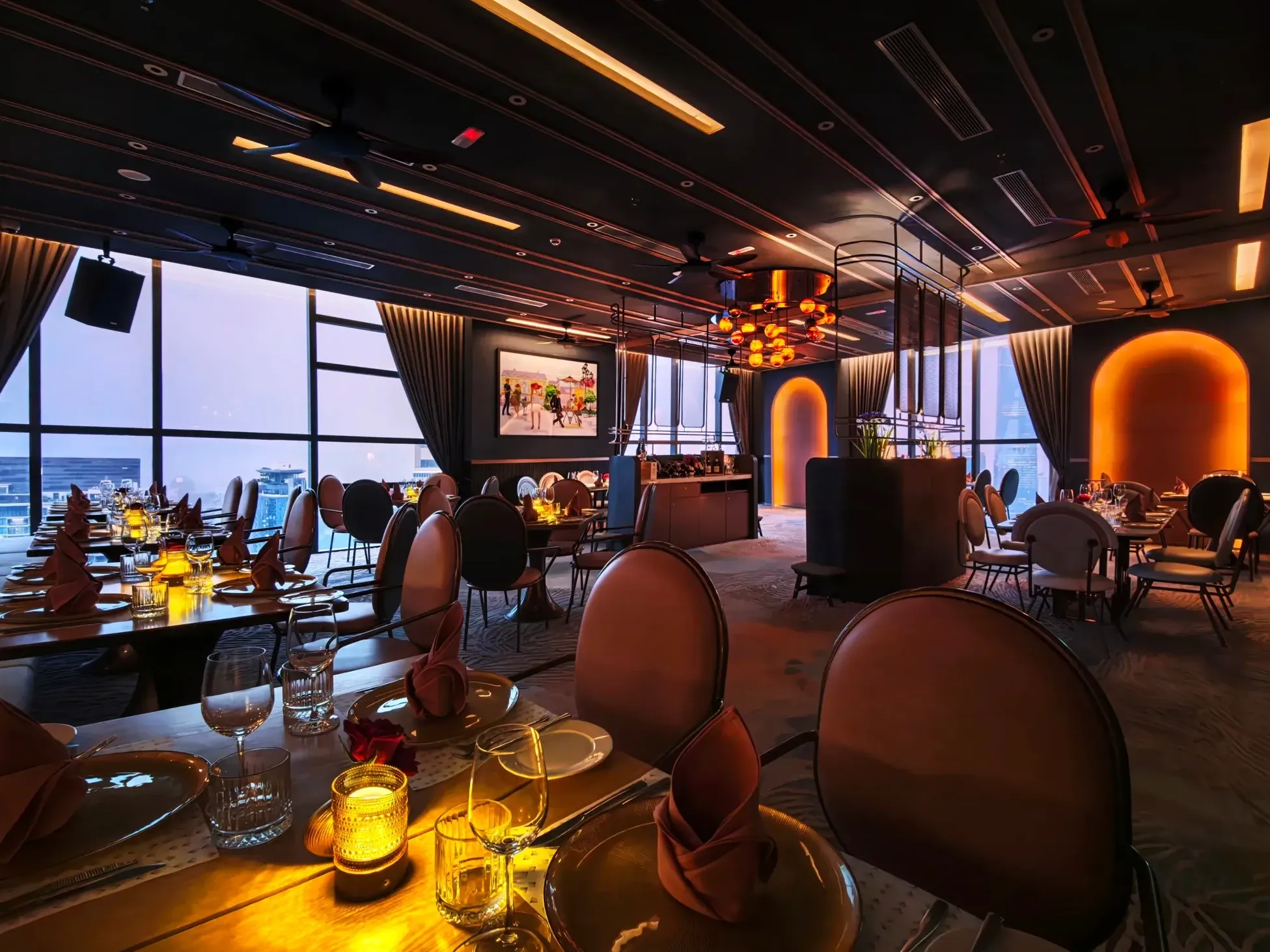 Moody and sophisticated evening dining room at Feast at FIFTY 1 with plush seating and warm lighting.