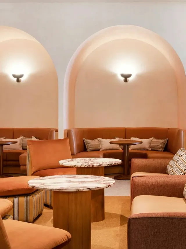 Cibaria\'s 55 North Bar at Elysium Manly with curved coral niches above leather banquettes, facing plush coral and chairs