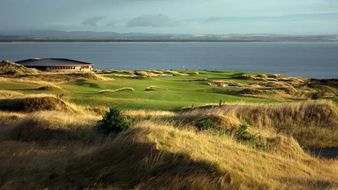 Scenic view of a coastal golf course, featuring lush greens, sandy dunes, and a clubhouse, near Seaton House