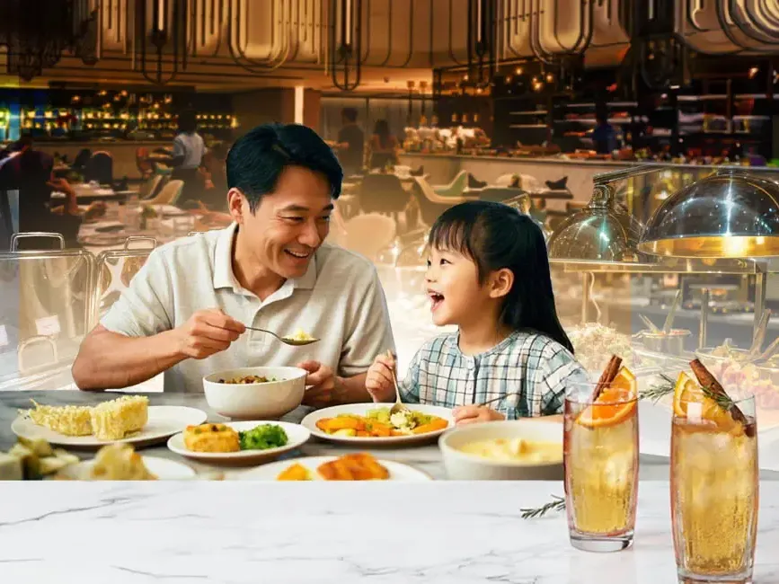A man and a child enjoying their food at a hotel restaurant - Imperial Lexis Kuala Lumpur