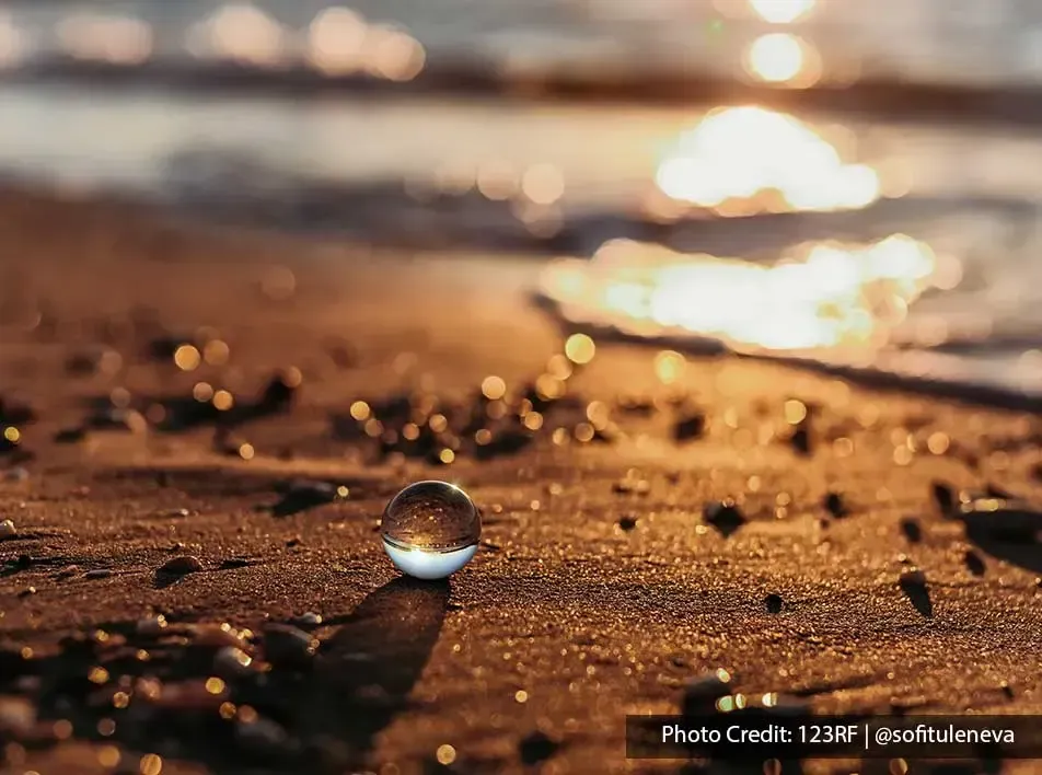 vibrant sunset casts a breathtaking reflection on the glistening sand - Grand Lexis PD