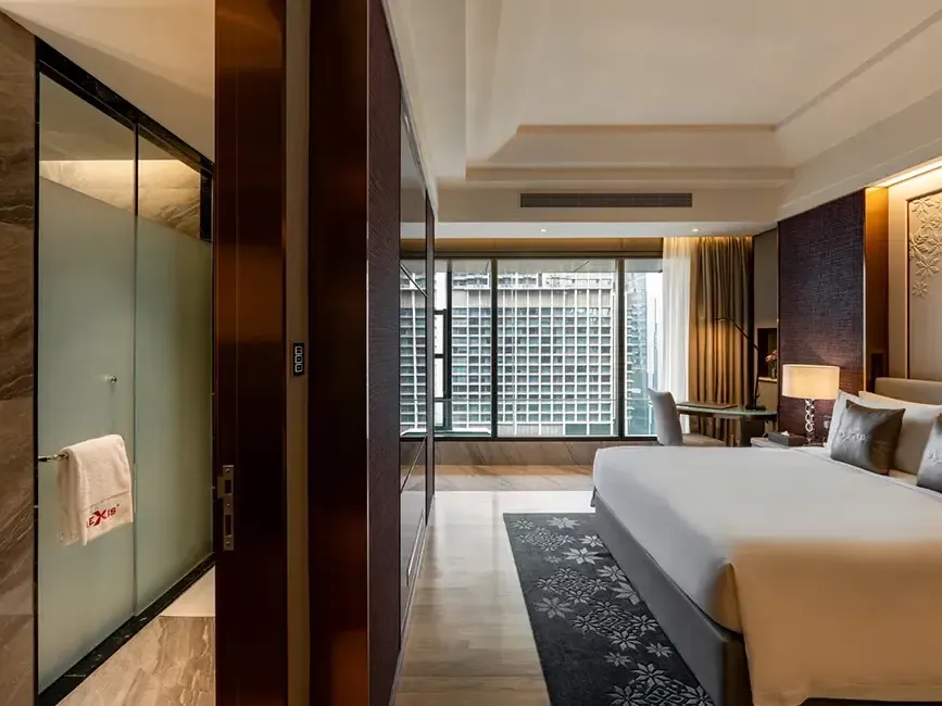 Entrance view of the luxury Executive Pool hotel room at Imperial Lexis KL showing the plush king bed.
