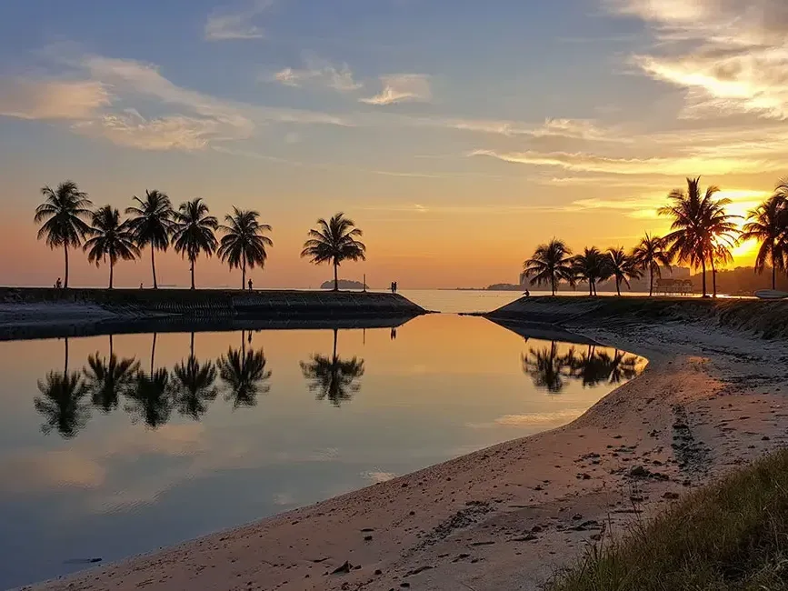 A stunning sunset casts vibrant colours over the water at Bagan Pinang Beach - Lexis Port Dickson