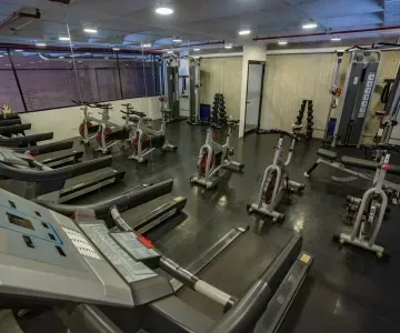 Fitness center with treadmills and exercise bikes by weight machines at Unika Hotels, the best places to stay in Bogota