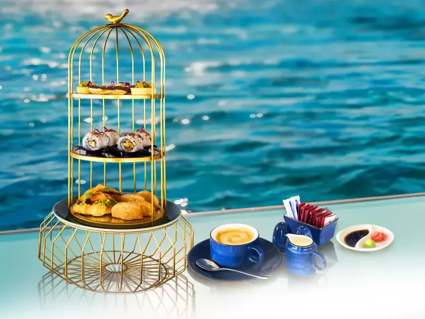 A decorative afternoon tea set surrounded by breathtaking view of the sea - Lexis Hibiscus Port Dickson
