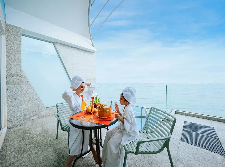 Guests enjoying refreshments at the Premium Pool Villa by the sea