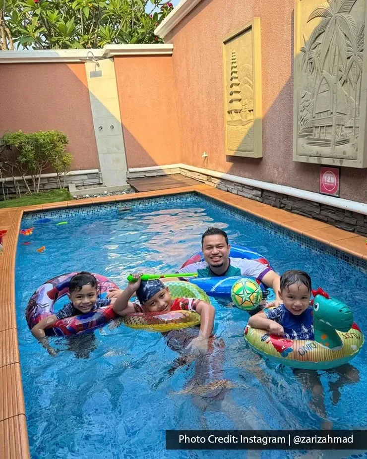 Adult and children playing with floats in pool.