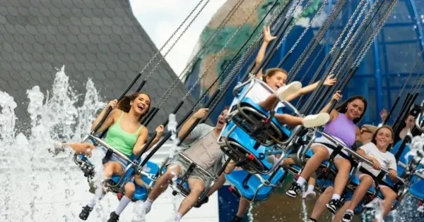 People laugh on a flying chair ride at Dreamworld