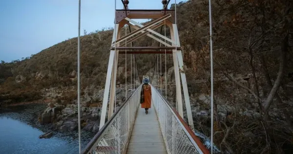 Woman walks across the Alexandra Suspension Bridge