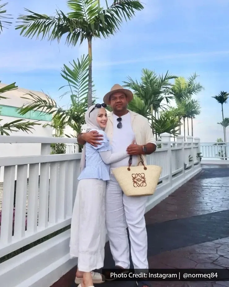 Couple dressed in white enjoying a sunny day at a beach resort.